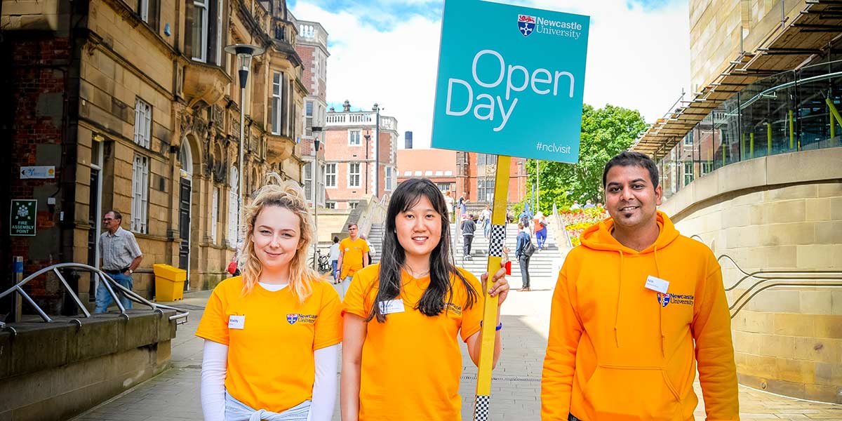 University Open Day students holding a welcome sign