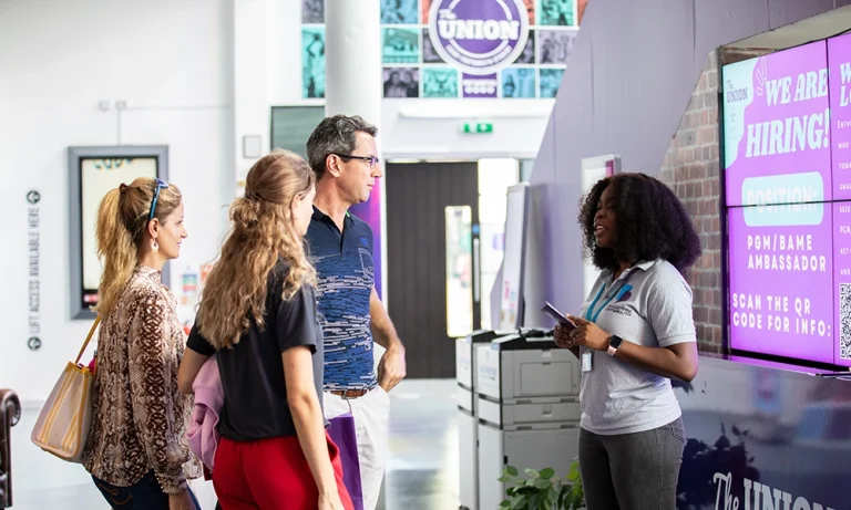 Student ambassador chatting to prospective students at a university open day