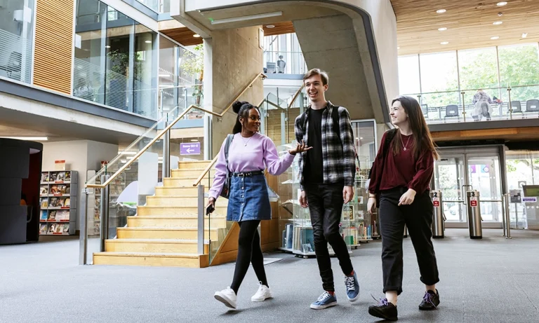 Uni students walking and chatting in campus building