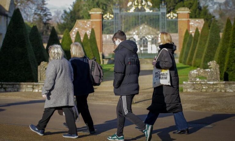 Students and parents or supporters walking across campus at a university open day at Bath Spa University
