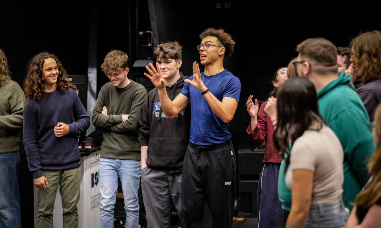 Bath Spa University student working with potential performing arts students at an open day