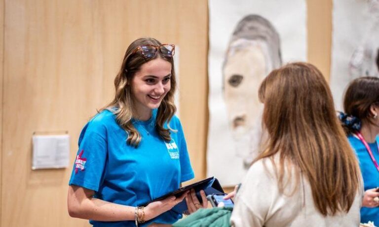 Bath Spa University open day welcome desk female student greeting potential student